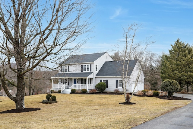 view of front of home with a front yard, covered porch, and roof with shingles