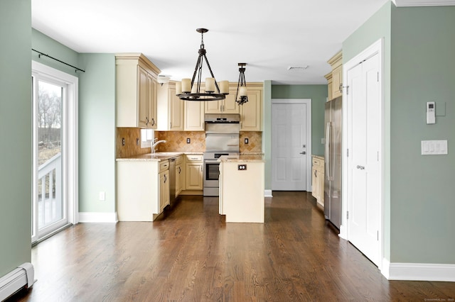 kitchen featuring a center island, a sink, baseboard heating, stainless steel appliances, and backsplash