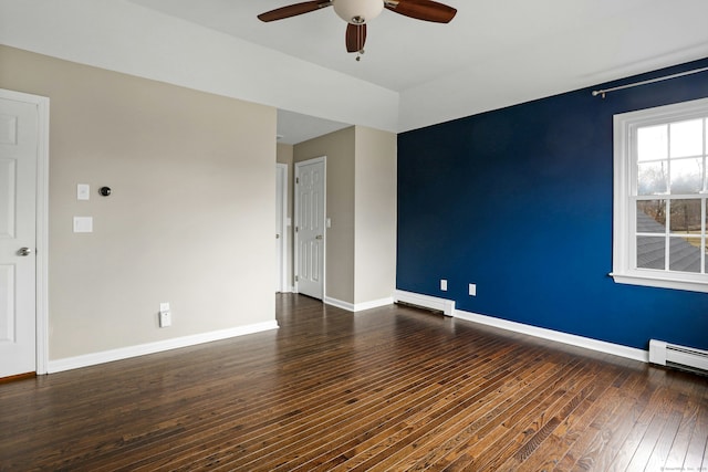 spare room with baseboards, a ceiling fan, hardwood / wood-style floors, baseboard heating, and a baseboard heating unit