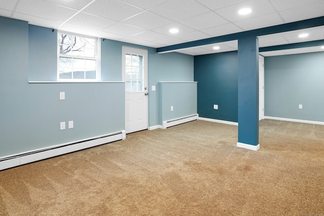 below grade area featuring baseboard heating, carpet, and baseboards