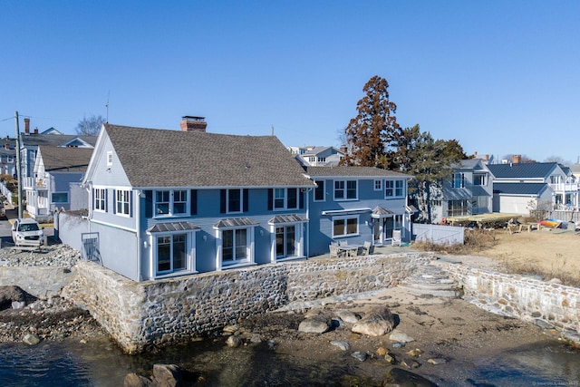 back of house featuring a water view