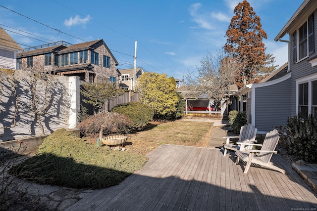 wooden terrace with a lawn