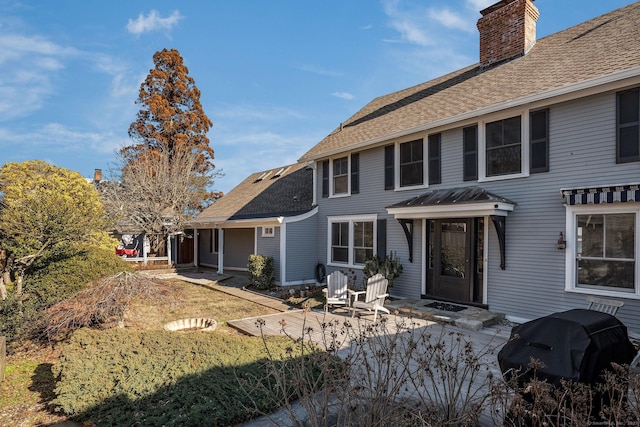 rear view of house with a yard