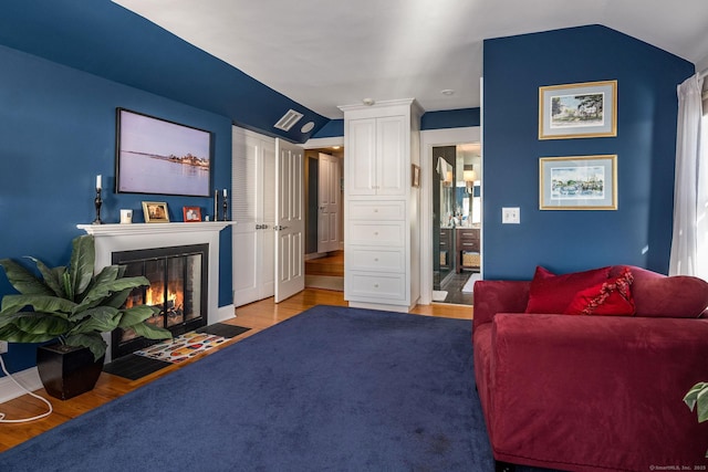 living room featuring vaulted ceiling and light hardwood / wood-style flooring