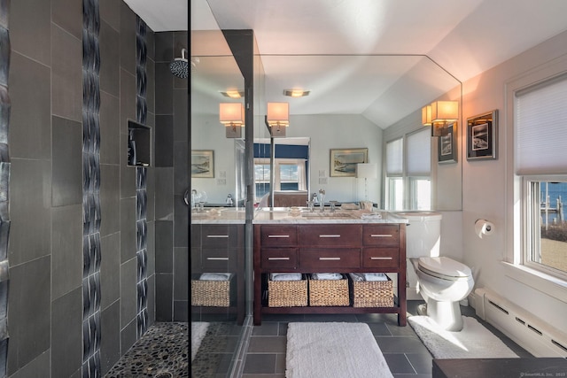 bathroom featuring tiled shower, toilet, vaulted ceiling, baseboard heating, and vanity