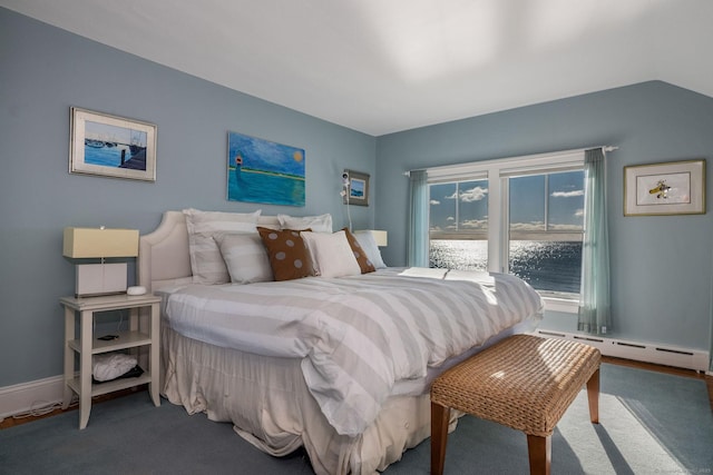 carpeted bedroom featuring a baseboard radiator and lofted ceiling