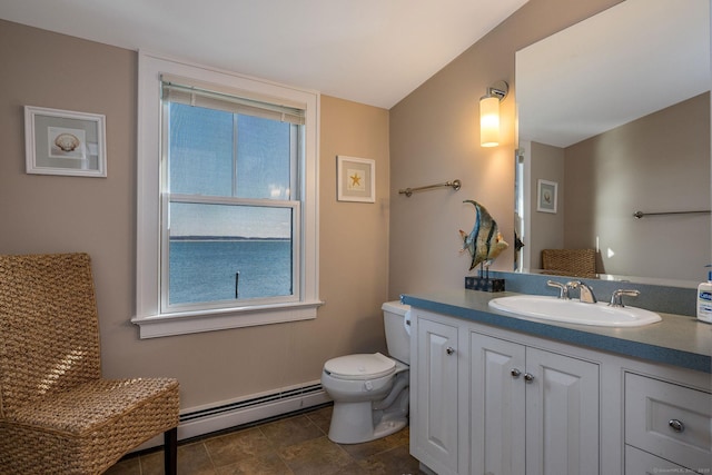 bathroom with a baseboard radiator, vanity, and toilet