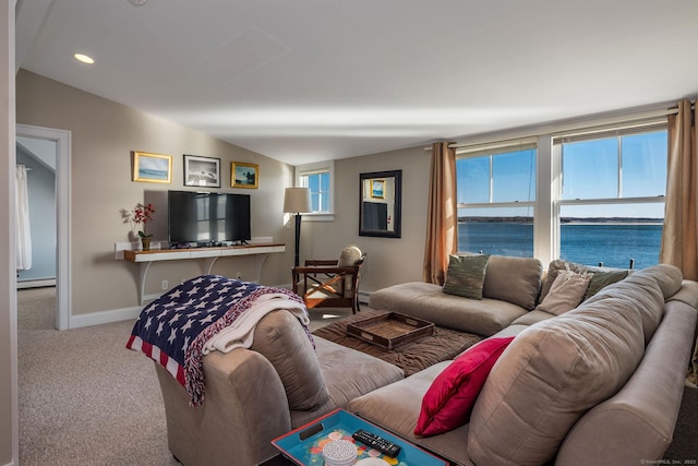 carpeted living room featuring a baseboard heating unit and vaulted ceiling