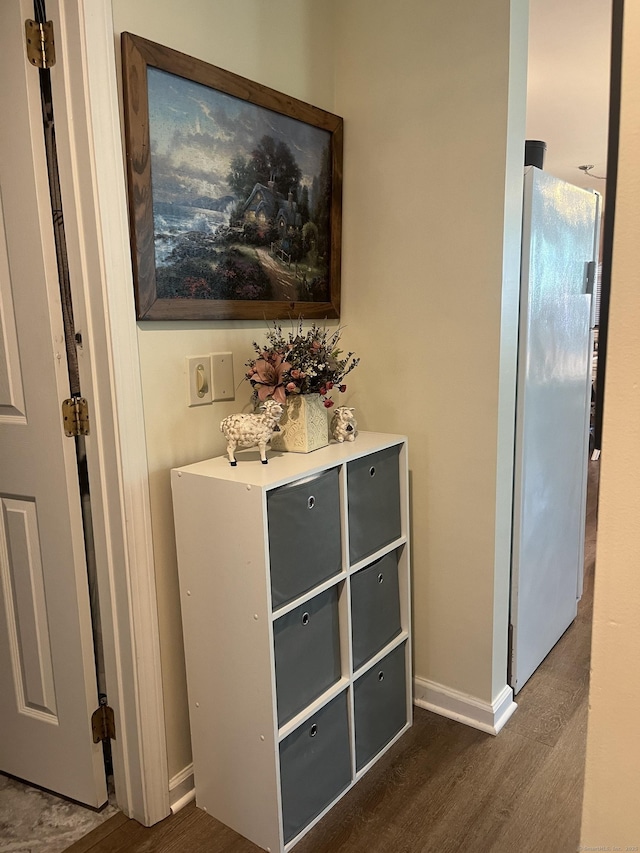 interior details featuring wood-type flooring and white fridge