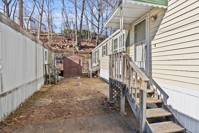 view of side of home featuring a storage shed