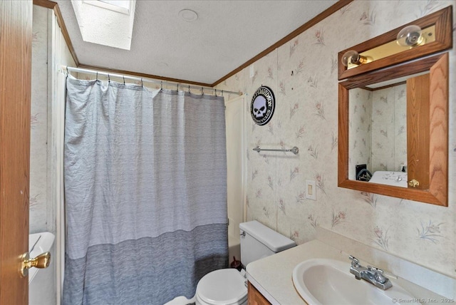 bathroom featuring toilet, crown molding, a skylight, a textured ceiling, and a shower with shower curtain