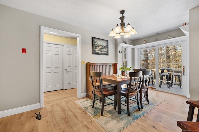 dining room featuring an inviting chandelier and light wood-type flooring