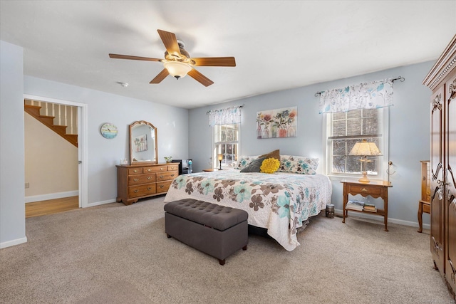 bedroom with light colored carpet and ceiling fan