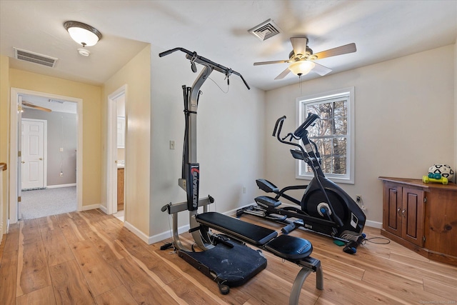 exercise area with ceiling fan and light hardwood / wood-style flooring