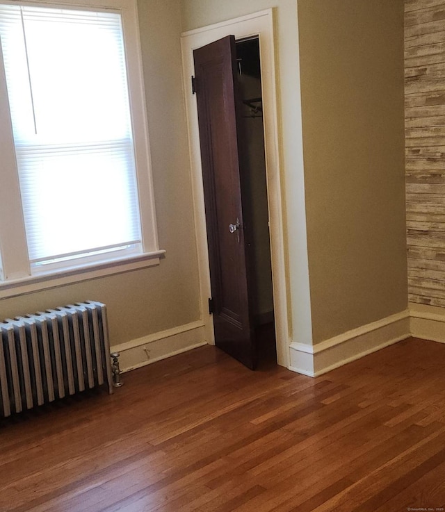 interior space featuring dark wood-type flooring and radiator