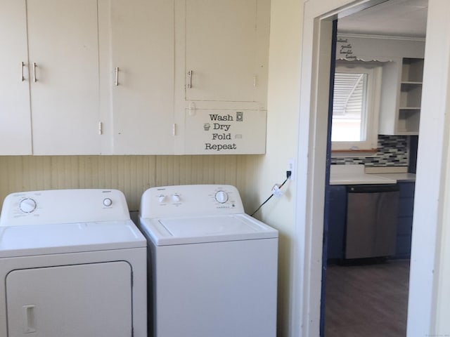 clothes washing area featuring hardwood / wood-style flooring, cabinets, and separate washer and dryer