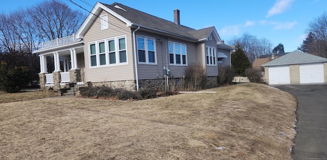 view of home's exterior featuring a garage, an outdoor structure, and a yard