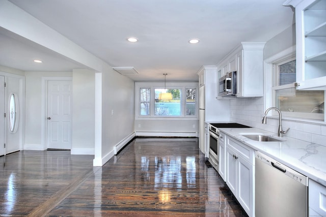 kitchen with sink, white cabinetry, light stone counters, pendant lighting, and stainless steel appliances