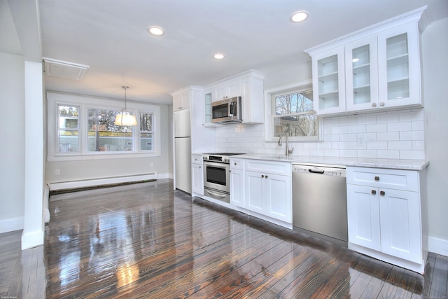 kitchen featuring a baseboard radiator, pendant lighting, stainless steel appliances, light stone countertops, and white cabinets