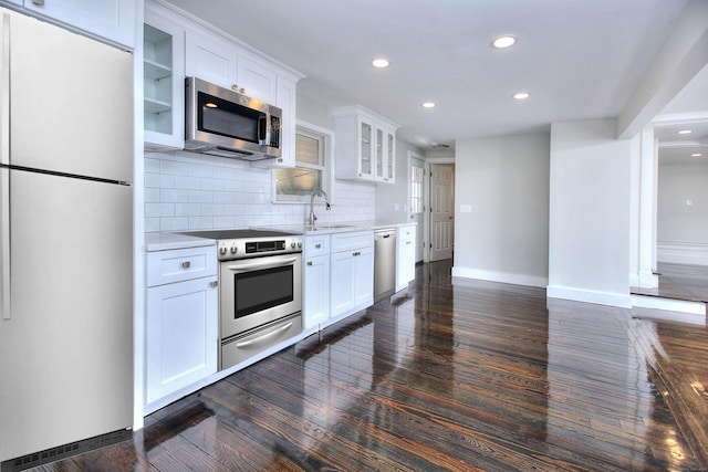 kitchen with stainless steel appliances, dark hardwood / wood-style floors, sink, and white cabinets