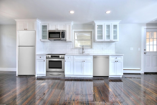 kitchen with white cabinetry, a baseboard heating unit, tasteful backsplash, and appliances with stainless steel finishes