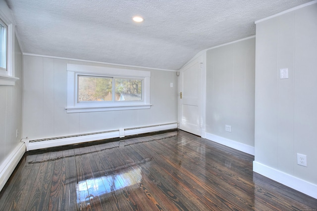 spare room featuring baseboard heating, lofted ceiling, dark hardwood / wood-style floors, and a textured ceiling