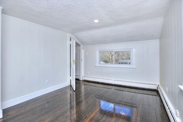 bonus room with vaulted ceiling, dark wood-type flooring, a textured ceiling, and baseboard heating