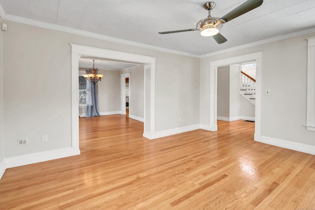 empty room featuring ceiling fan with notable chandelier, ornamental molding, and light hardwood / wood-style floors