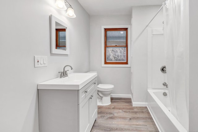 full bathroom with vanity, hardwood / wood-style floors, toilet, and shower / bath combo with shower curtain