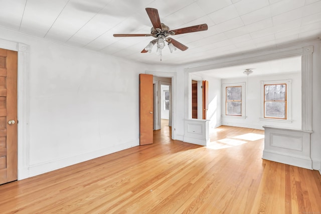 empty room featuring ornamental molding, ceiling fan, and light hardwood / wood-style flooring