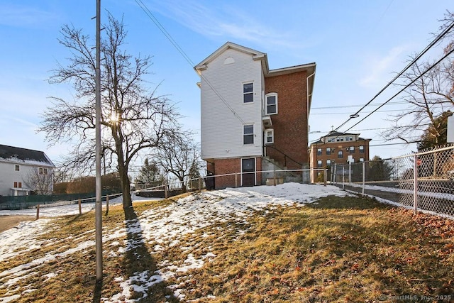 view of snow covered rear of property