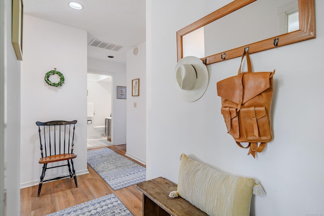 hallway with light hardwood / wood-style flooring