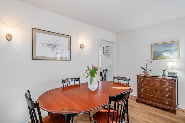 dining space with light hardwood / wood-style flooring