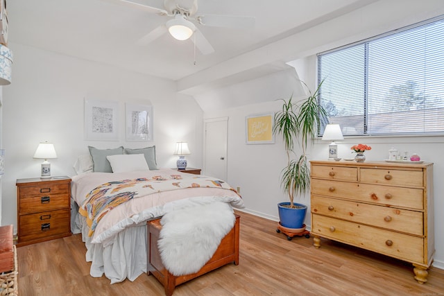 bedroom with vaulted ceiling, light wood-type flooring, and ceiling fan