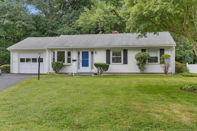 ranch-style home featuring a garage and a front lawn