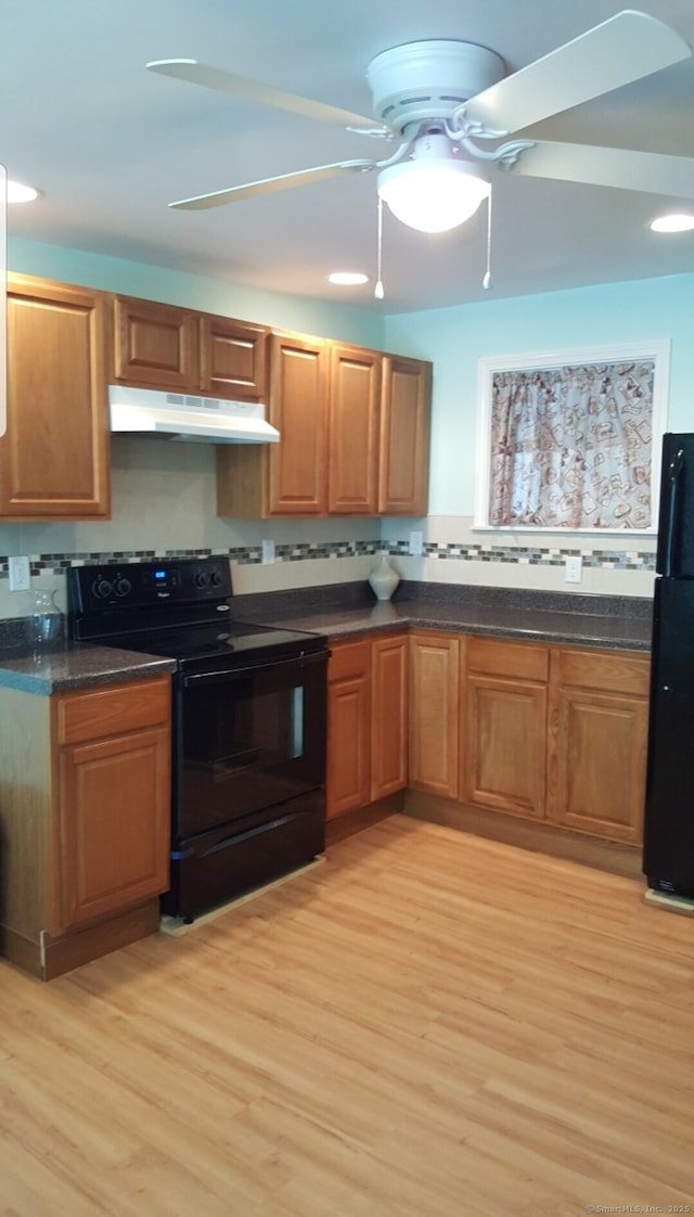 kitchen featuring light hardwood / wood-style flooring, backsplash, ceiling fan, and black appliances