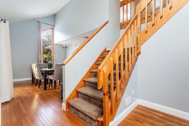 stairway with hardwood / wood-style floors