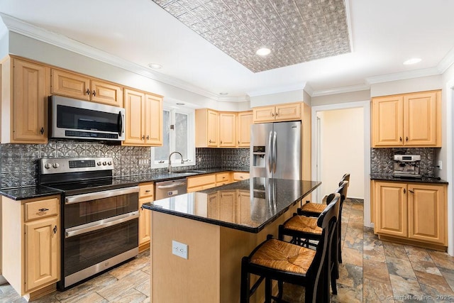 kitchen with a kitchen island, appliances with stainless steel finishes, sink, a breakfast bar area, and crown molding