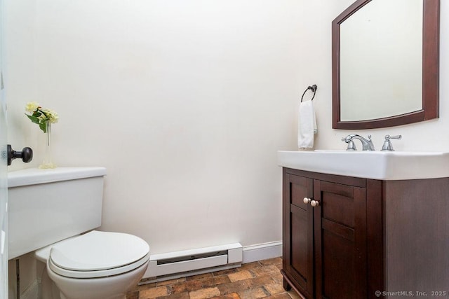 bathroom featuring vanity, baseboard heating, and toilet