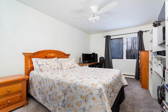 carpeted bedroom featuring ceiling fan and baseboard heating