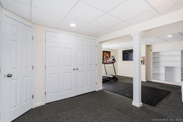 exercise room with dark carpet and built in shelves