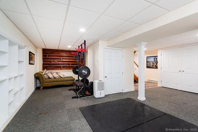 exercise area with dark colored carpet and a baseboard radiator