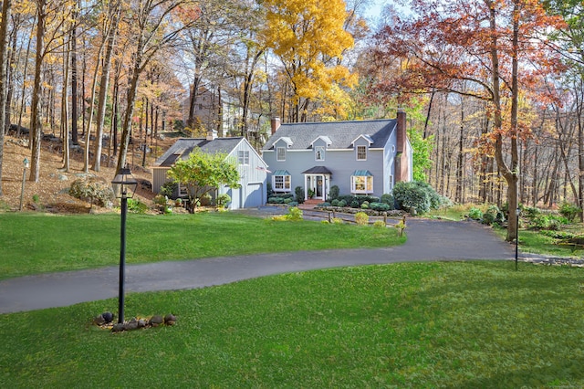 view of front of property featuring a garage and a front lawn