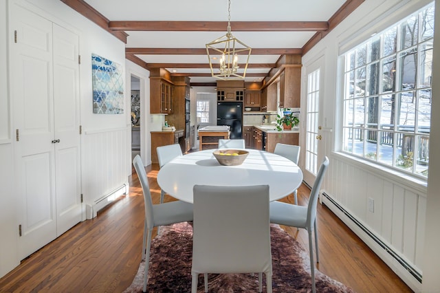 dining area with beam ceiling, plenty of natural light, dark wood-type flooring, and baseboard heating