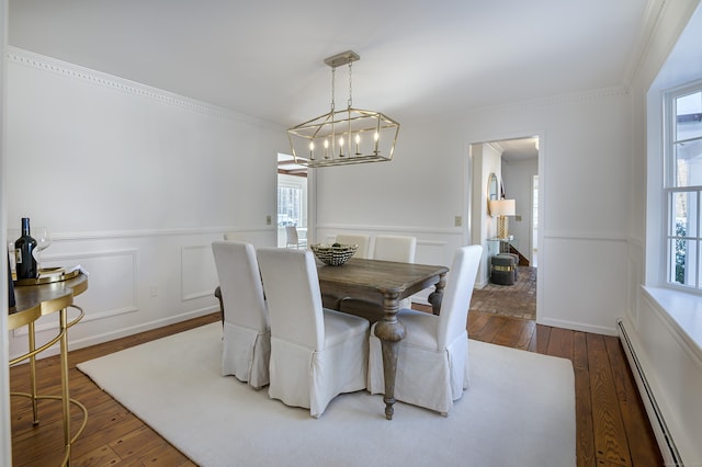 dining space featuring crown molding, dark hardwood / wood-style floors, and baseboard heating