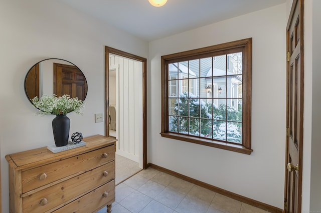 doorway to outside with light tile patterned flooring and plenty of natural light