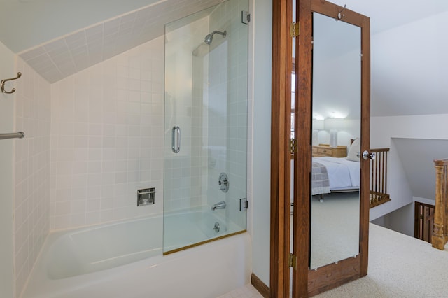 bathroom with lofted ceiling and bath / shower combo with glass door