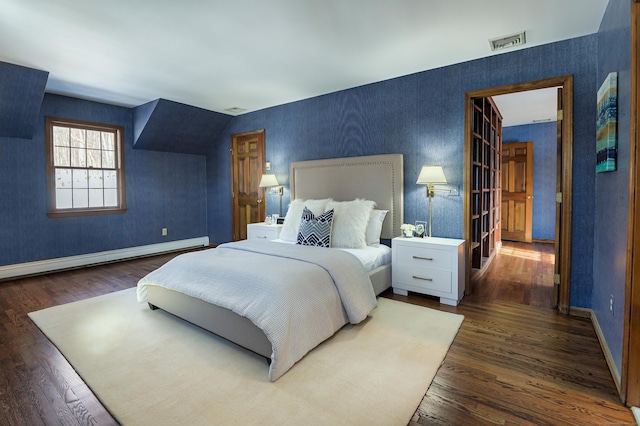 bedroom featuring dark hardwood / wood-style floors and baseboard heating