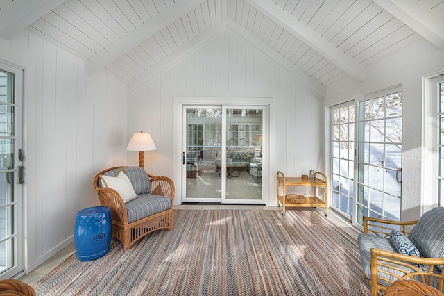 sitting room featuring vaulted ceiling with beams, wooden ceiling, and carpet