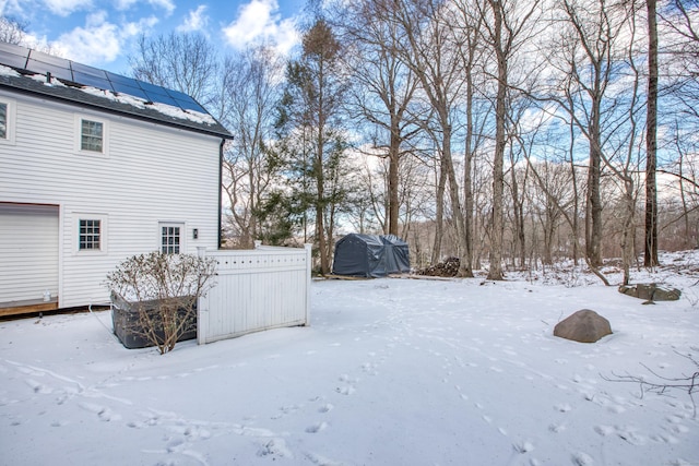 yard covered in snow featuring a garage